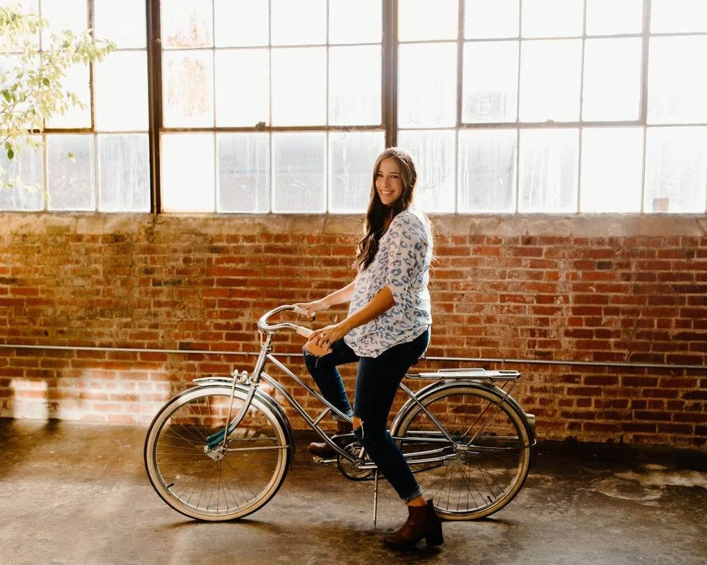 A woman on a bike in a building 
