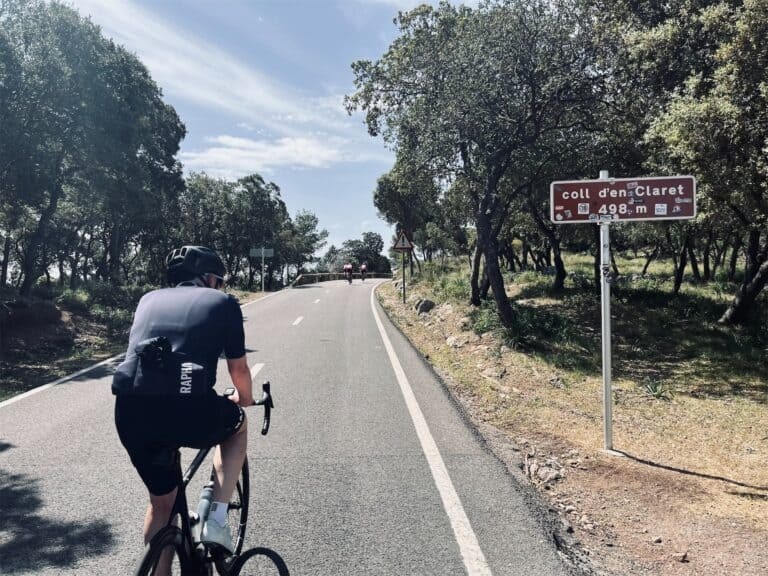 a cyclist riding up hills