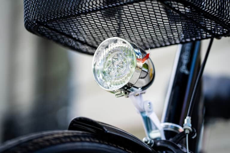 A close up of a bicycle with a light attached to it.