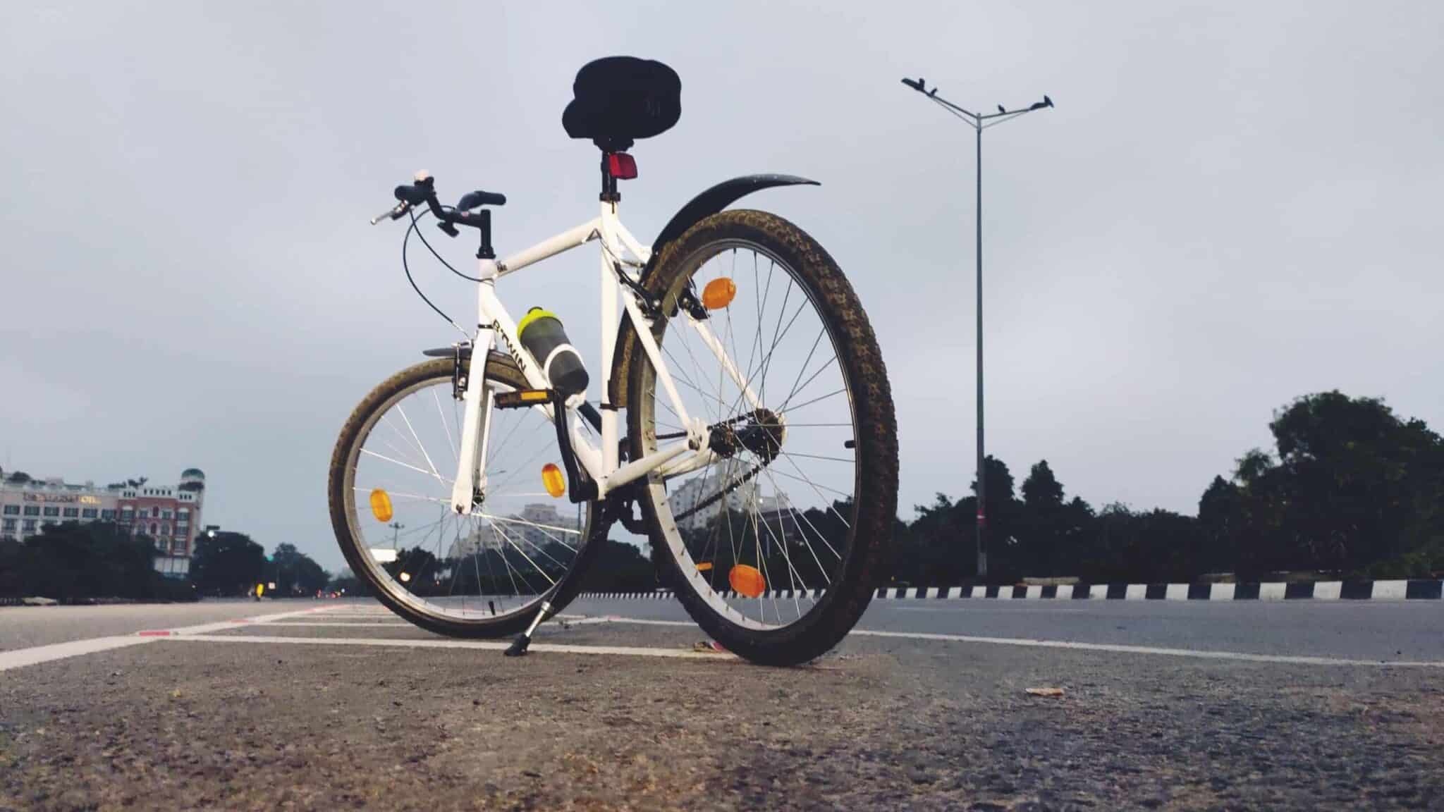 White and black road bike on road