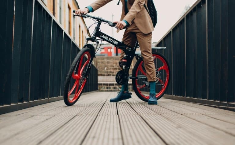 Young businessman in a suit with a bicycle