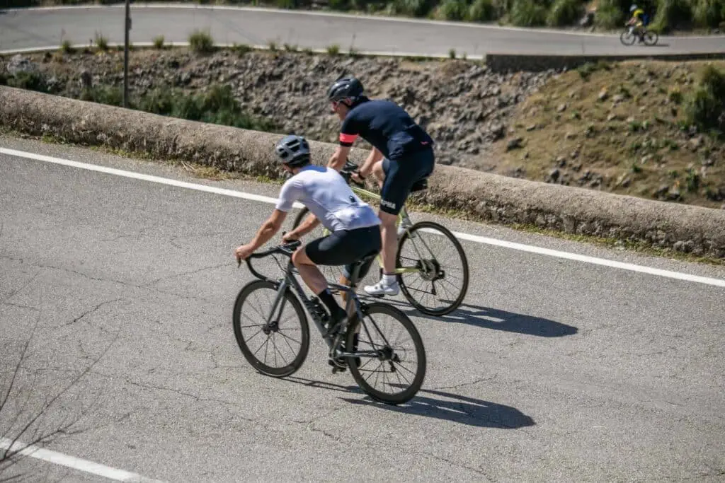 back shot of two cyclists back shot of two cyclists