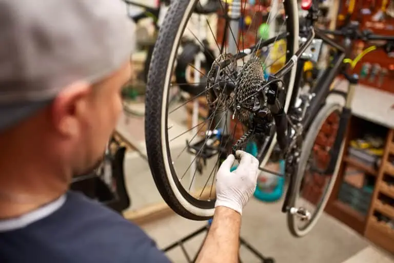 Bicycle mechanic in a workshop in the repair process