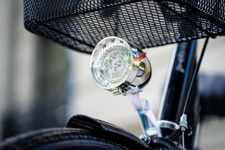 A close up of a bicycle with a light attached to it.