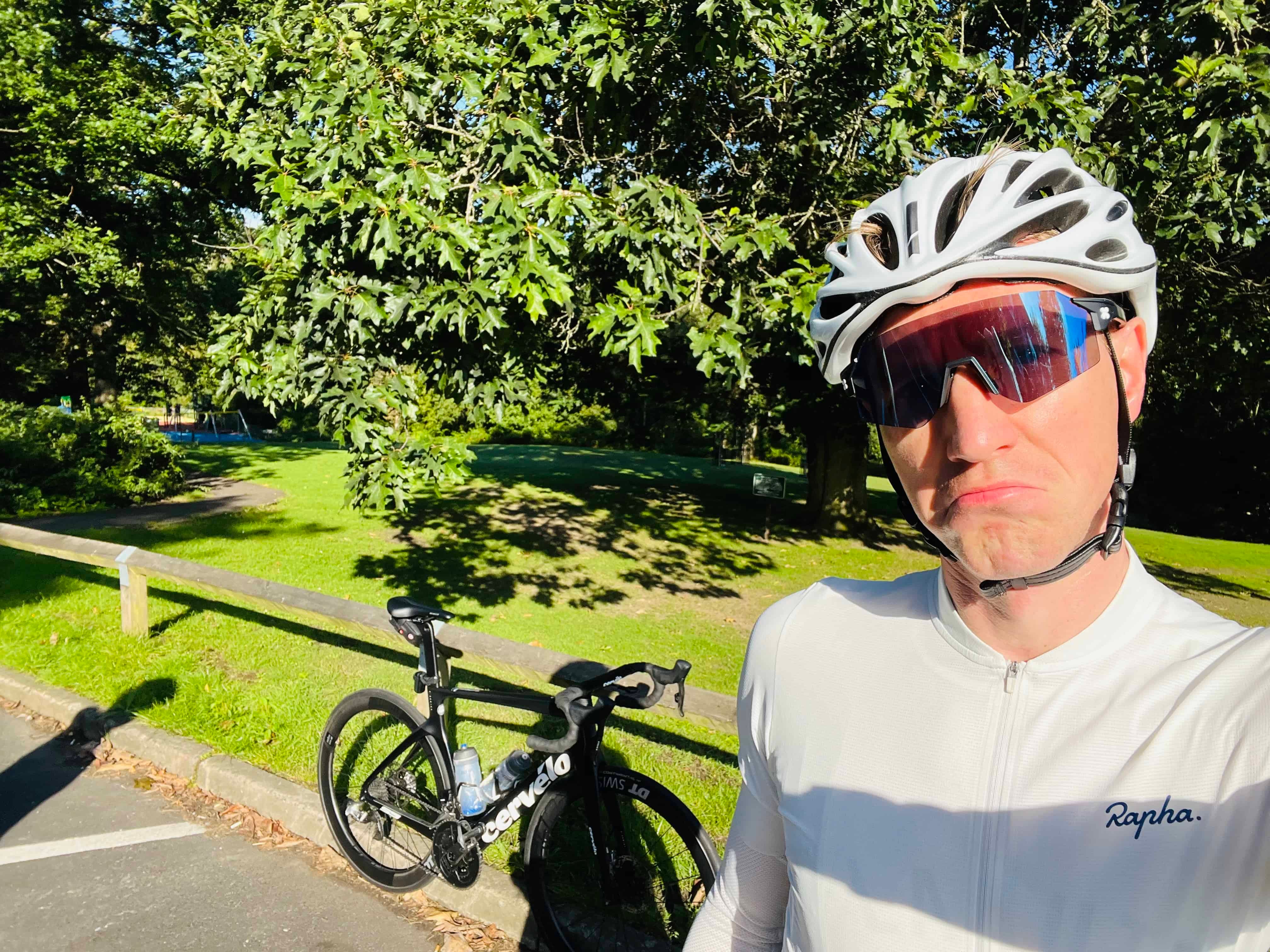 A man is taking a selfie with his bike.